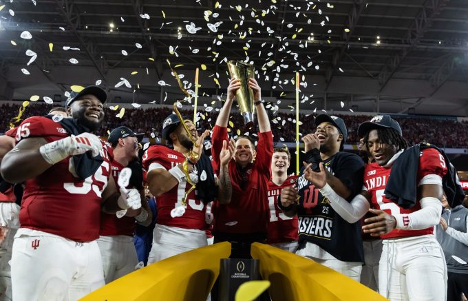 Jan 19, 2026; Miami Gardens, FL, USA; Indiana Hoosiers head coach Curt Cignetti hoists the trophy as he celebrates with defensive lineman Tyrique Tucker (95), wide receiver Elijah Sarratt (13), quarterback Fernando Mendoza (16), defensive lineman Mikail Kamara and defensive back D'Angelo Ponds (5) after defeating the Miami Hurricanes in the College Football Playoff National Championship game at Hard Rock Stadium.