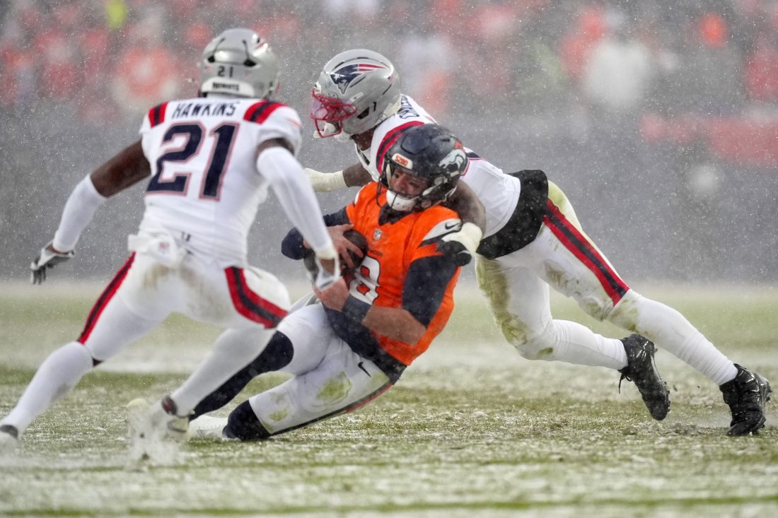 Jan 25, 2026; Denver, CO, USA; Denver Broncos quarterback Jarrett Stidham (8) rushes the ball against the New England Patriots during the second half in the 2026 AFC Championship Game at Empower Field at Mile High. Mandatory Credit: Ron Chenoy-Imagn Images