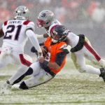 Jan 25, 2026; Denver, CO, USA; Denver Broncos quarterback Jarrett Stidham (8) rushes the ball against the New England Patriots during the second half in the 2026 AFC Championship Game at Empower Field at Mile High. Mandatory Credit: Ron Chenoy-Imagn Images