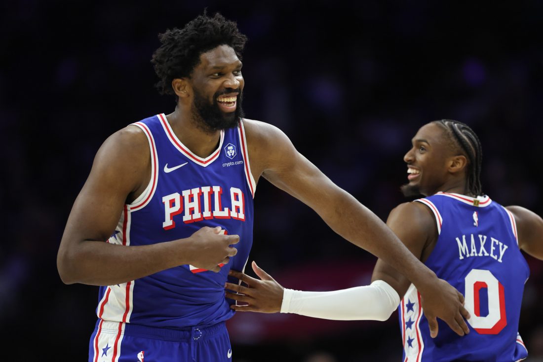 Jan 27, 2026; Philadelphia, Pennsylvania, USA; Philadelphia 76ers center Joel Embiid (21) celebrates with guard Tyrese Maxey (0) after their alley oop dunk connection against the Milwaukee Bucks during the second quarter at Xfinity Mobile Arena. Mandatory Credit: