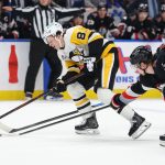 Feb 5, 2026; Buffalo, New York, USA; Buffalo Sabres defenseman Bowen Byram (4) knocks the puck off the stick of Pittsburgh Penguins center Ben Kindel (81) during the third period at KeyBank Center. Mandatory