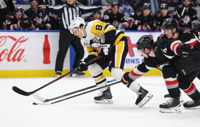 Feb 5, 2026; Buffalo, New York, USA; Buffalo Sabres defenseman Bowen Byram (4) knocks the puck off the stick of Pittsburgh Penguins center Ben Kindel (81) during the third period at KeyBank Center. Mandatory