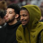 Feb 7, 2026; Portland, Oregon, USA; Memphis Grizzlies guards Scotty Pippen Jr. (1, left) and Ja Morant (12) watch from the bench during the first half against the Portland Trail Blazers at Moda Center.