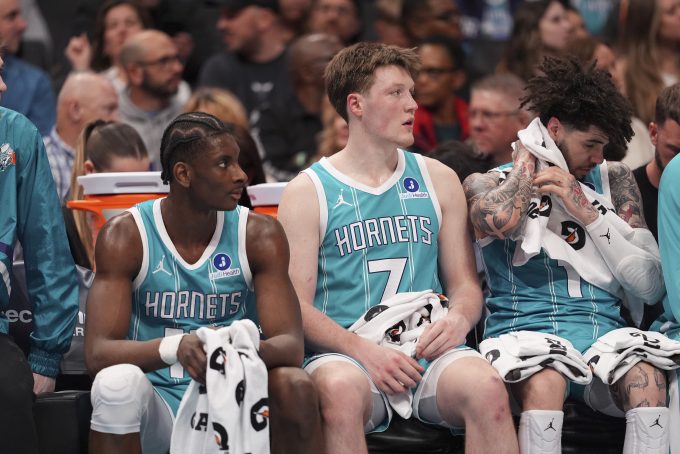 Feb 9, 2026; Charlotte, North Carolina, USA; Charlotte Hornets forward Moussa Diabaté (14) and guard/forward Kon Knueppel (7) and guard LaMelo Ball (1) get a break during the second quarter against the Detroit Pistons at Spectrum Center. Mandatory Credit: Jim Dedmon-Imagn Images