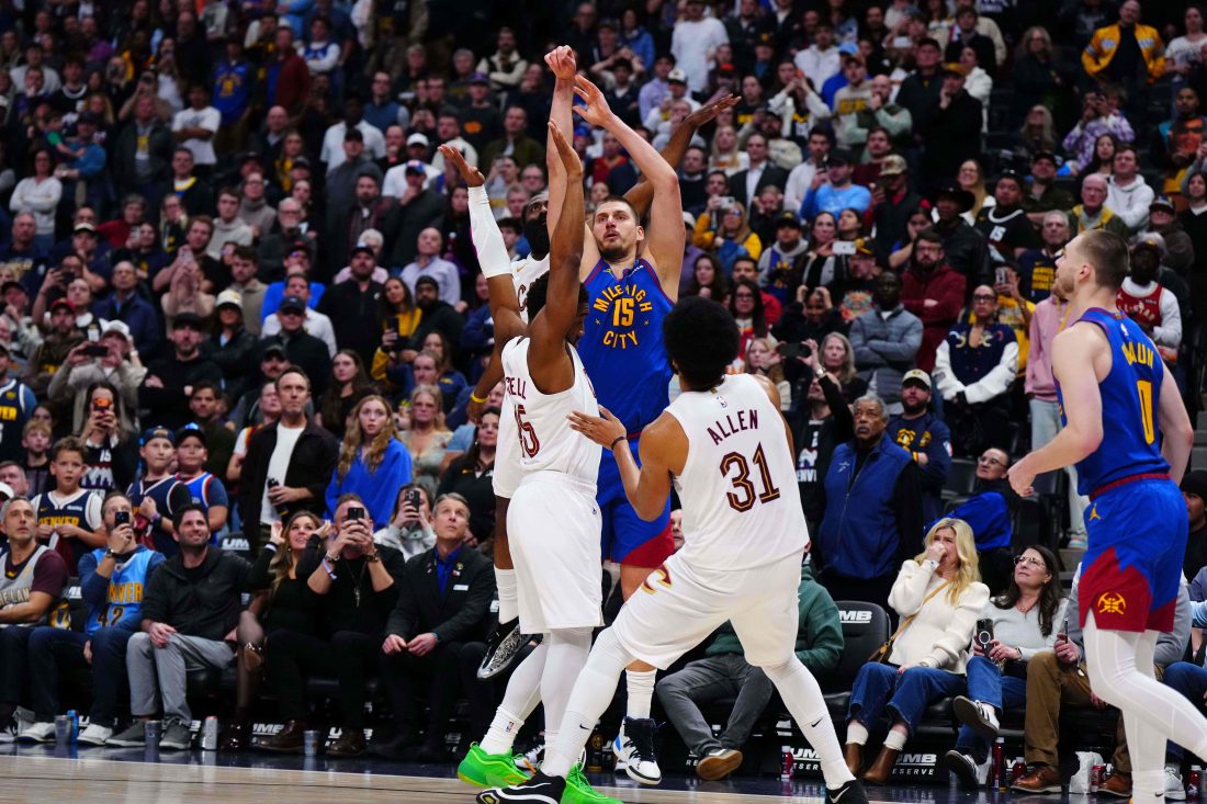Feb 9, 2026; Denver, Colorado, USA; Cleveland Cavaliers guard Donovan Mitchell (45) and center Jarrett Allen (31) defend the final shot by Denver Nuggets center Nikola Jokic (15) during the fourth quarter at Ball Arena. Mandatory Credit: Ron Chenoy-Imagn Images