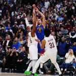 Feb 9, 2026; Denver, Colorado, USA; Cleveland Cavaliers guard Donovan Mitchell (45) and center Jarrett Allen (31) defend the final shot by Denver Nuggets center Nikola Jokic (15) during the fourth quarter at Ball Arena. Mandatory Credit: Ron Chenoy-Imagn Images