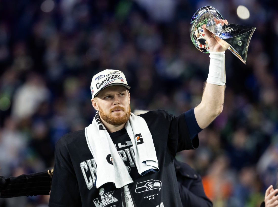 Feb 8, 2026; Santa Clara, CA, USA; Seattle Seahawks quarterback Sam Darnold (14) celebrates with the Vince Lombardi Trophy after defeating the New England Patriots during Super Bowl LX at Levi's Stadium. Mandatory Credit: Mark J. Rebilas-Imagn Images