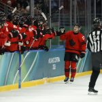 Feb 15, 2026; Milan, Italy; Macklin Celebrini of Canada celebrates scoring their fifth goal with teammates against France in men's ice hockey group A play during the Milano Cortina 2026 Olympic Winter Games at Milano Santagiulia Ice Hockey Arena. Mandatory Credit: