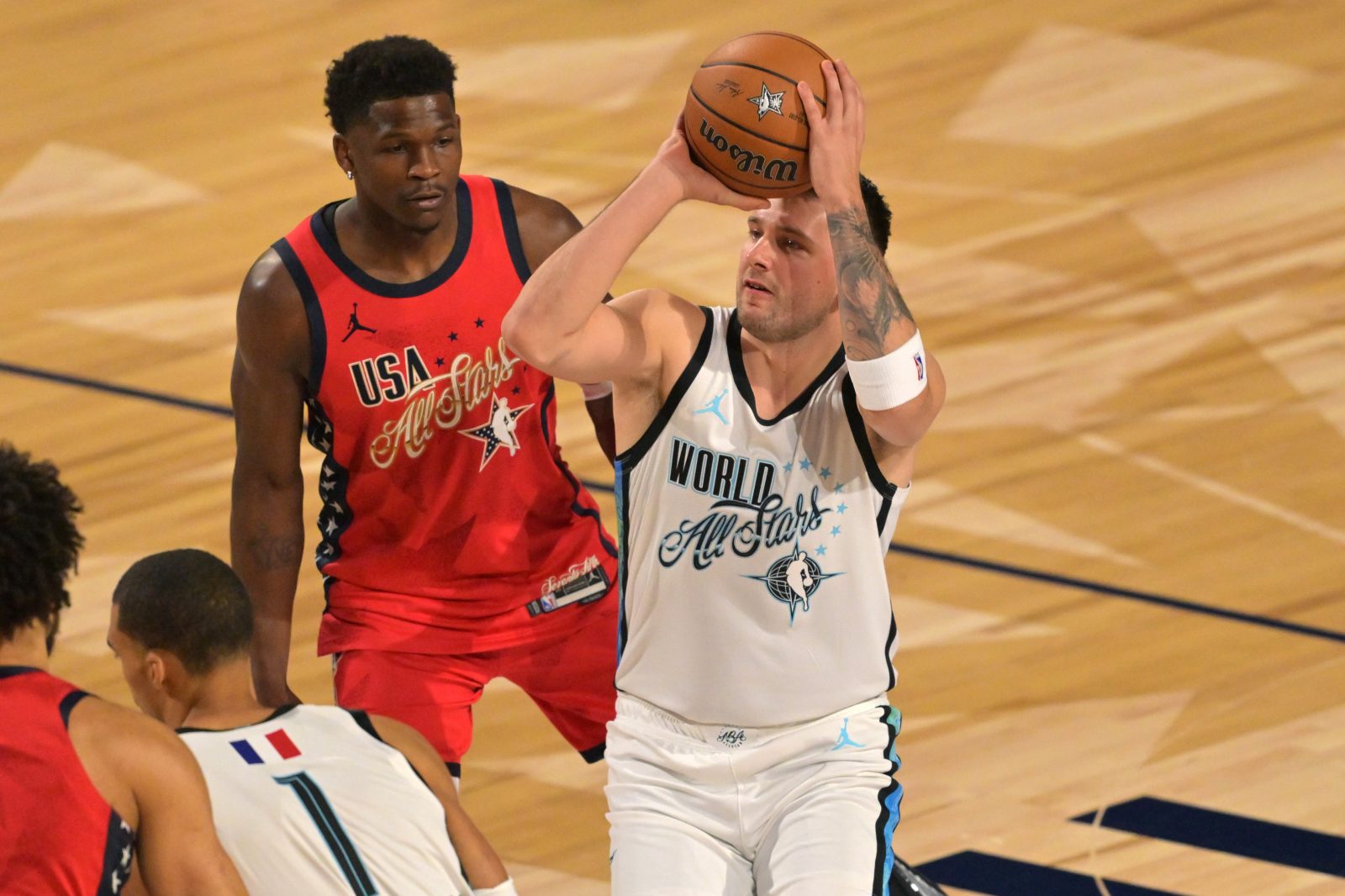Feb 15, 2026; Inglewood, California, USA; Team World guard Luka Doncic (77) of the Los Angeles Lakers shoots against Team USA Stars guard Anthony Edwards (5) of the Minnesota Timberwolves in game one during the 75th NBA All Star Game at Intuit Dome. Mandatory Credit: Jayne Kamin-Oncea-Imagn Images