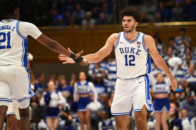 Feb 16, 2026; Durham, North Carolina, USA; Duke Blue Devils forward Cameron Boozer (12) celebrates with Duke Blue Devils center Patrick Ngongba II (21) during the during the second half against the Syracuse Orange at Cameron Indoor Stadium. Mandatory Credit: Zachary Taft-Imagn Images