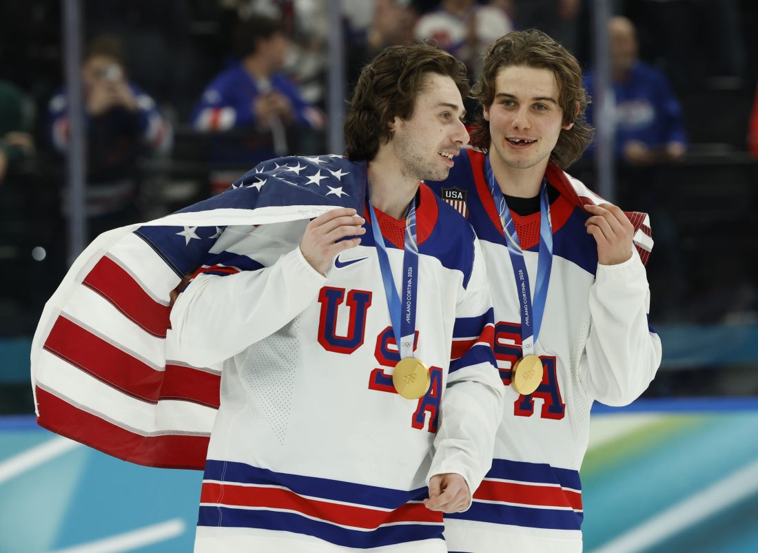 Feb 22, 2026; Milan, Italy; Quinn Hughes (43) of the United States and Jack Hughes (86) of the United States celebrate after defeating Canada in the men's ice hockey gold medal game during the Milano Cortina 2026 Olympic Winter Games at Milano Santagiulia Ice Hockey Arena. Mandatory Credit: Geoff Burke-Imagn Images