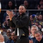 Feb 22, 2026; San Francisco, California, USA; Golden State Warriors guard Stephen Curry (30) cheers from the bench during a game against the Denver Nuggets in the third quarter at Chase Center.