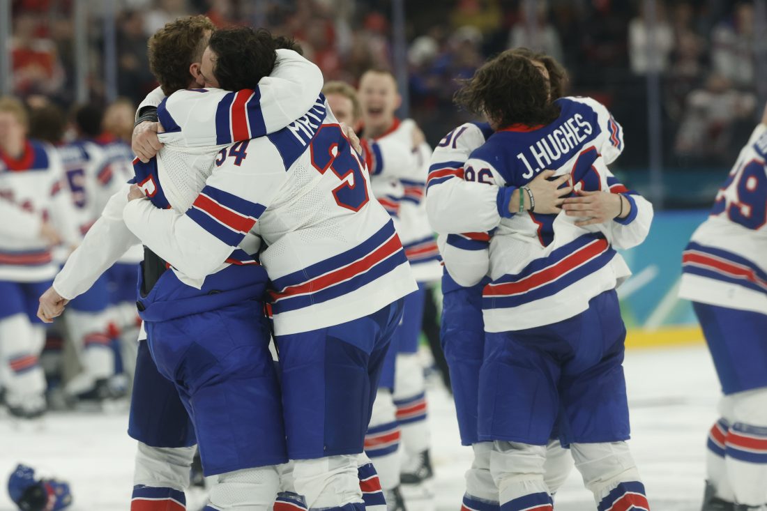 Feb 22, 2026; Milan, Italy; Team USA players celebrate after a golden goal in overtime by Jack Hughes #86 of Team United States during the Milano Cortina 2026 Olympic Winter Games at Milano Santagiulia Ice Hockey Arena. Mandatory Credit: