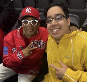 McNeese Men's basketball manager Amir Khan sitting next to world-class film director Spike Lee.
