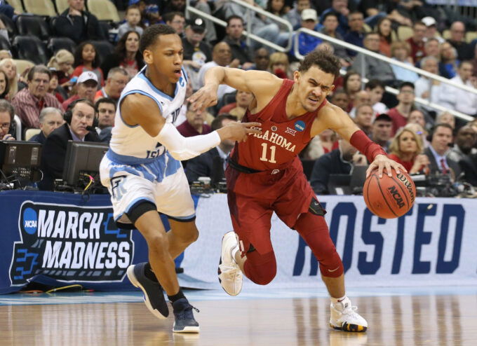 Mar 15, 2018; Pittsburgh, PA, USA; Oklahoma Sooners guard Trae Young (11) dribbles against Rhode Island Rams guard Fatts Russell (2) during the first half in the first round of the 2018 NCAA Tournament at PPG Paints Arena. Rhode Island won 83-78 in overtime. Mandatory Credit: Charles LeClaire-USA TODAY Sports