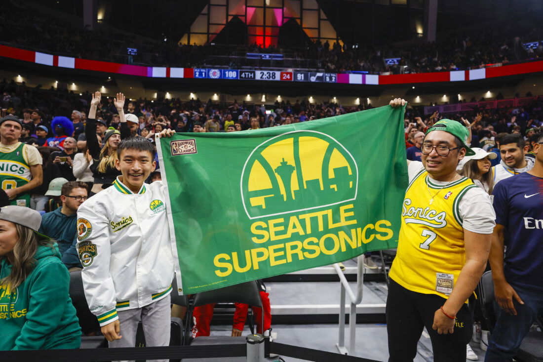 Oct 10, 2023; Seattle, Washington, USA; Fans hold a flag for the Seattle Supersonics during the fourth quarter of a game between the Utah Jazz and LA Clippers at Climate Pledge Arena. Mandatory Credit: Joe Nicholson-USA TODAY Sports