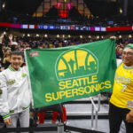 Oct 10, 2023; Seattle, Washington, USA; Fans hold a flag for the Seattle Supersonics during the fourth quarter of a game between the Utah Jazz and LA Clippers at Climate Pledge Arena. Mandatory Credit: Joe Nicholson-USA TODAY Sports