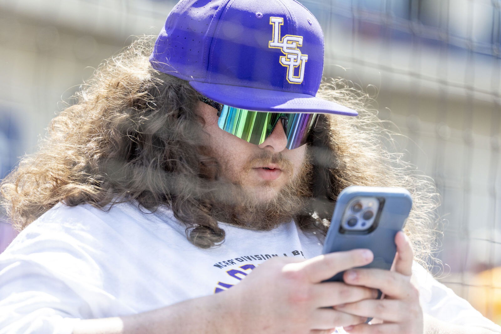 May 26, 2024; Hoover, AL, USA; A fan checks his phone during the championship game between Tennessee and LSU at the SEC Baseball Tournament at Hoover Metropolitan Stadium. Mandatory Credit: Vasha Hunt-USA TODAY Sports