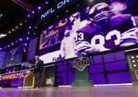 Apr 25, 2025; Green Bay, WI, USA; Former Minnesota Vikings tight end Stu Voigt announces the team’s selection with the 102nd overall pick during the third round of the 2025 NFL Draft at Lambeau Field. Mandatory Credit: Tork Mason/USA Today Network via Imagn Images