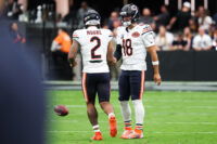 Sep 28, 2025; Paradise, Nevada, USA; Chicago Bears quarterback Caleb Williams (18) shakes hands with wide receiver DJ Moore (2) during warm ups prior to the game against the Las Vegas Raiders at Allegiant Stadium. Mandatory Credit: Kiyoshi Mio-Imagn Images