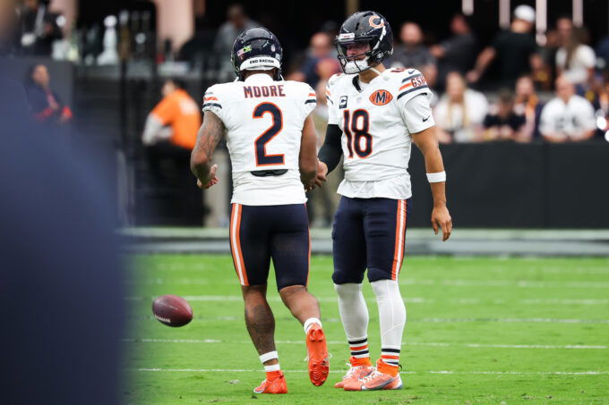 Sep 28, 2025; Paradise, Nevada, USA; Chicago Bears quarterback Caleb Williams (18) shakes hands with wide receiver DJ Moore (2) during warm ups prior to the game against the Las Vegas Raiders at Allegiant Stadium. Mandatory Credit: Kiyoshi Mio-Imagn Images