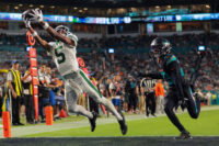 Sep 29, 2025; Miami Gardens, Florida, USA; New York Jets wide receiver Garrett Wilson (5) attempts to make a catch against Miami Dolphins cornerback Artie Burns (23) during the second half at Hard Rock Stadium. Mandatory Credit: Sam Navarro-Imagn Images
