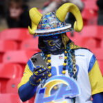 Oct 19, 2025; London, England; Los Angeles Rams fan looks at their phone before a NFL International Series game between the Los Angeles Rams and the Jacksonville Jaguars at Wembley Stadium. Mandatory Credit: Andrew Boyers-Reuters via Imagn Images