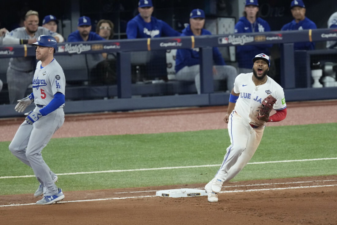 Nov 1, 2025; Toronto, Ontario, CAN; Los Angeles Dodgers first baseman Freddie Freeman (5) is out against Toronto Blue Jays first baseman Vladimir Guerrero Jr. (27) on a double play in the seventh inning during game seven of the 2025 MLB World Series at Rogers Centre. Mandatory Credit: Kevin Sousa-Imagn Images