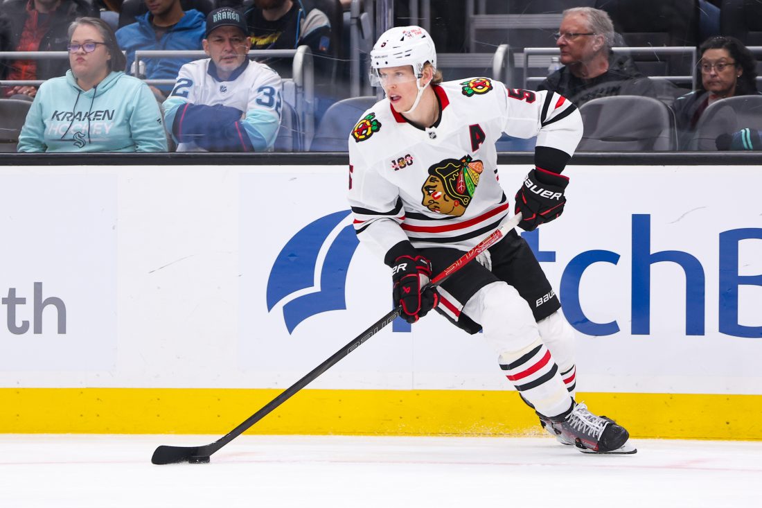 Nov 3, 2025; Seattle, Washington, USA; Chicago Blackhawks defenseman Connor Murphy (5) controls the puck in the second period against the Seattle Kraken at Climate Pledge Arena. Mandatory Credit: Kevin Ng-Imagn Images