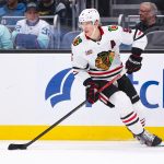 Nov 3, 2025; Seattle, Washington, USA; Chicago Blackhawks defenseman Connor Murphy (5) controls the puck in the second period against the Seattle Kraken at Climate Pledge Arena. Mandatory Credit: Kevin Ng-Imagn Images
