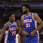 Nov 4, 2025; Chicago, Illinois, USA; Philadelphia 76ers guard VJ Edgecombe (77) chats with center Joel Embiid (21) during the first half of an NBA game against the Chicago Bulls at United Center. Mandatory Credit: Kamil Krzaczynski-Imagn Images