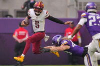 Dec 7, 2025; Minneapolis, Minnesota, USA; Washington Commanders quarterback Jayden Daniels (5) rushes the ball past Minnesota Vikings outside linebacker Andrew van Ginkel (43) during the first half at U.S. Bank Stadium. Mandatory Credit: Brad Rempel-Imagn Images