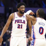 Jan 9, 2026; Orlando, Florida, USA; Philadelphia 76ers center Joel Embiid (21) reacts to guard Tyrese Maxey (0) against the Orlando Magic in the third quarter at Kia Center. Mandatory Credit: Nathan Ray Seebeck-Imagn Images