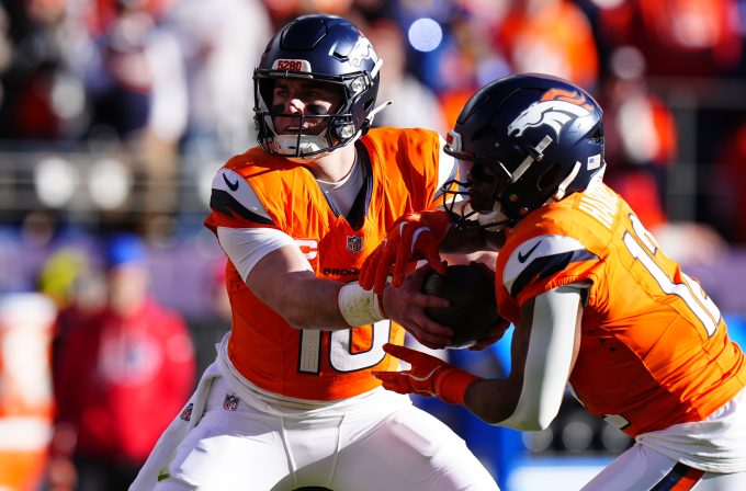 Jan 17, 2026; Denver, CO, USA; Denver Broncos quarterback Bo Nix (10) hands off to running back RJ Harvey (12) during the first quarter of an AFC Divisional Round playoff game against the Buffalo Bills at Empower Field at Mile High. Mandatory Credit: Ron Chenoy-Imagn Images