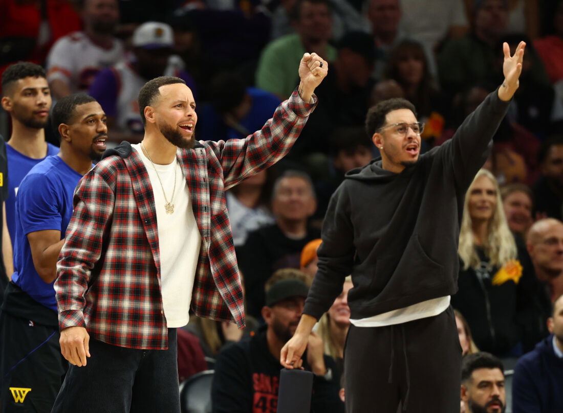 Feb 5, 2026; Phoenix, Arizona, USA; Golden State Warriors guard Stephen Curry (left) and brother Seth Curry react against the Phoenix Suns in the second half at Mortgage Matchup Center. Mandatory Credit: Mark J. Rebilas-Imagn Images