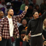 Feb 5, 2026; Phoenix, Arizona, USA; Golden State Warriors guard Stephen Curry (left) and brother Seth Curry react against the Phoenix Suns in the second half at Mortgage Matchup Center. Mandatory Credit: Mark J. Rebilas-Imagn Images
