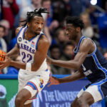 Jan 24, 2026; Columbia, Missouri, USA; Kansas Jayhawks guard Darryn Peterson (22) looks to pass against BYU Cougars forward AJ Dybantsa (3) during the first half at Mizzou Arena. Mandatory Credit: Jay Biggerstaff-Imagn Images