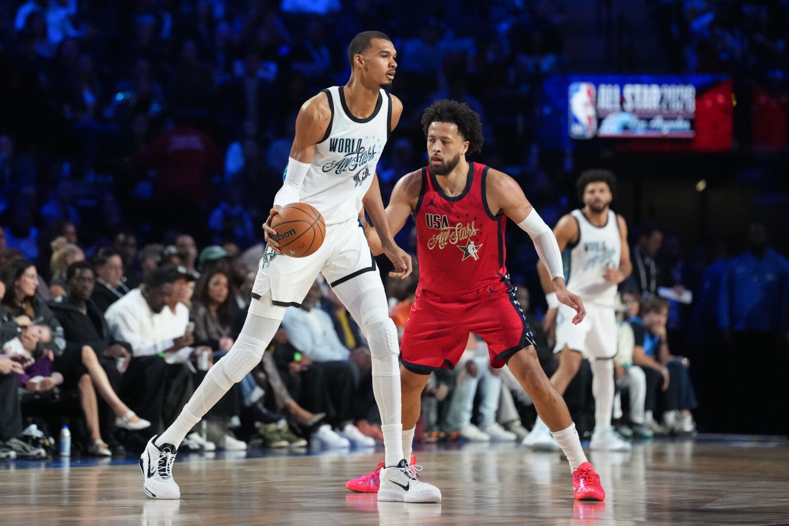 Feb 15, 2026; Inglewood, California, USA; Team World center Victor Wembanyama (1) of the San Antonio Spurs controls the ball while defend by Team USA Stars guard Cade Cunningham (2) of the Detroit Pistons in game one during the 75th NBA All Star Game at Intuit Dome. Mandatory Credit: Kirby Lee-Imagn Images