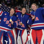 Feb 19, 2026; Milan, Italy; Aerin Frankel (31) of the United States, Gwyneth Philips (33) of the United States and Ava McNaughton (30) of the United States celebrate after winning the gold medal in women's ice hockey after defeating Canada during the Milano Cortina 2026 Olympic Winter Games at Milano Santagiulia Ice Hockey Arena. Mandatory Credit: Amber Searls-Imagn Images