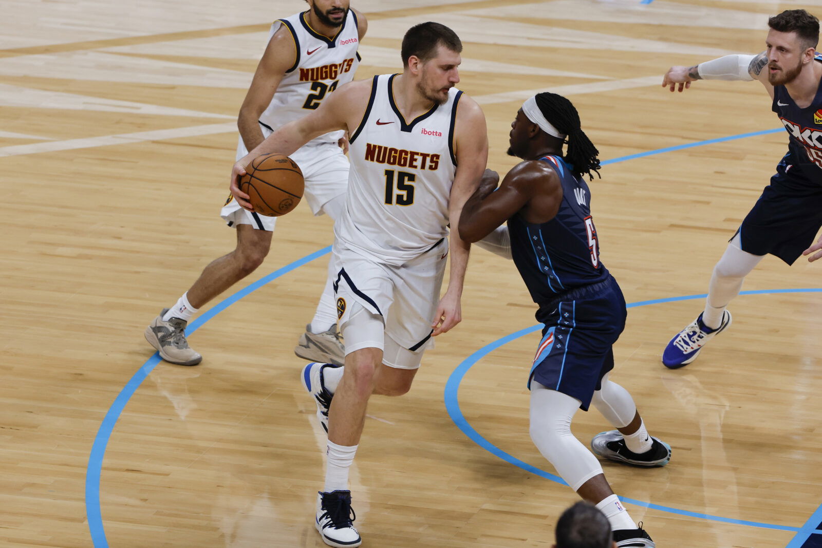Feb 27, 2026; Oklahoma City, Oklahoma, USA; Denver Nuggets center Nikola Jokić (15) drives against Oklahoma City Thunder guard Luguentz Dort (5) during the second quarter at Paycom Center. Mandatory Credit: Alonzo Adams-Imagn Images