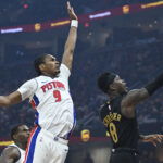 Mar 3, 2026; Cleveland, Ohio, USA; Cleveland Cavaliers guard Dennis Schroder (8) lays up a shot beside Detroit Pistons guard Ausar Thompson (9) in the third quarter at Rocket Arena. Mandatory Credit: David Richard-Imagn Images