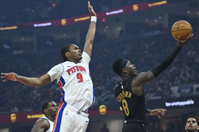 Mar 3, 2026; Cleveland, Ohio, USA; Cleveland Cavaliers guard Dennis Schroder (8) lays up a shot beside Detroit Pistons guard Ausar Thompson (9) in the third quarter at Rocket Arena. Mandatory Credit: David Richard-Imagn Images