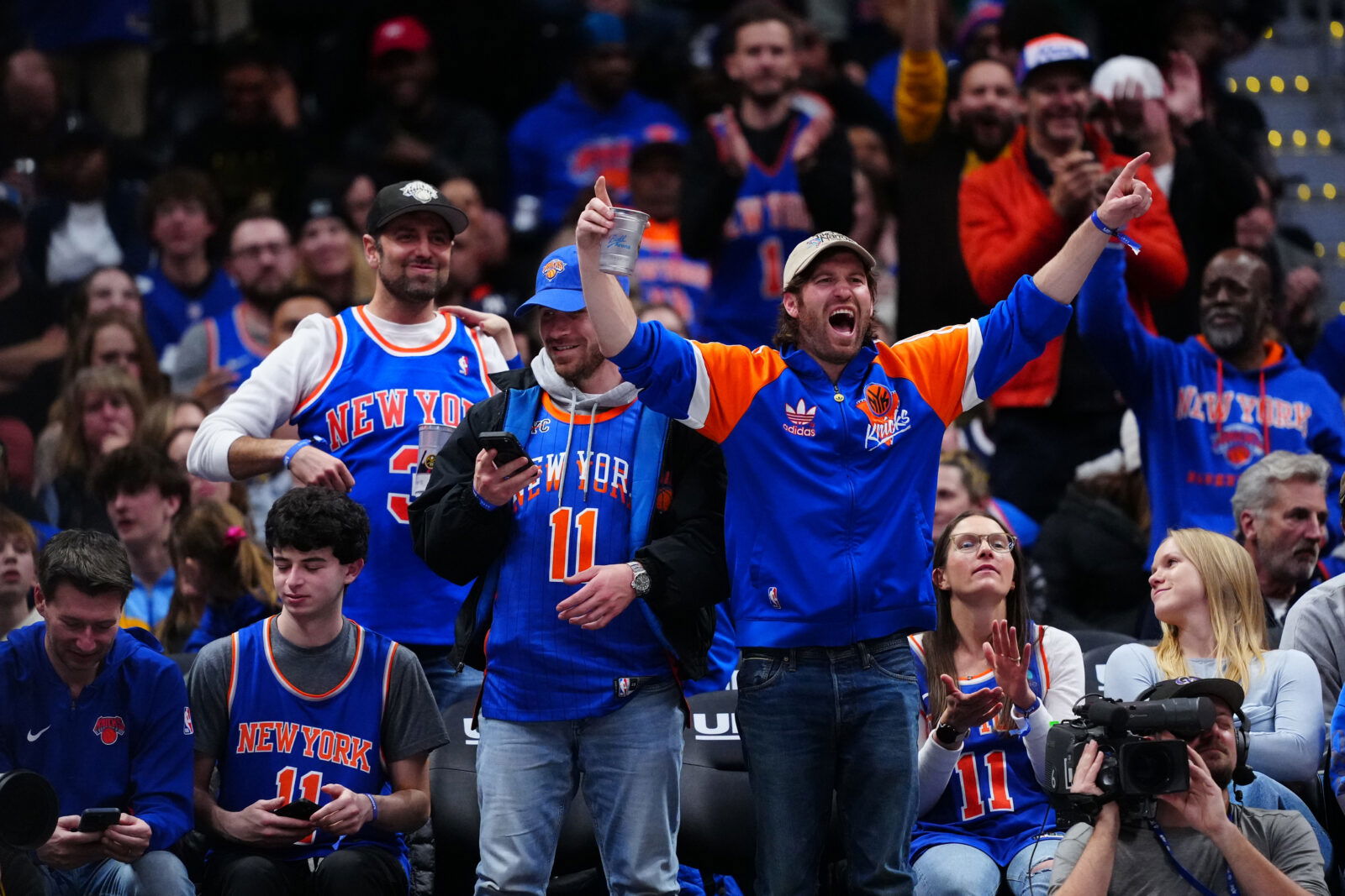 Mar 6, 2026; Denver, Colorado, USA; New York Knicks fans react in the fourth quarter against the Denver Nuggets at Ball Arena. Mandatory Credit: Ron Chenoy-Imagn Images