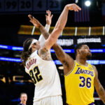 Mar 14, 2026; Los Angeles, California, USA; Denver Nuggets forward Aaron Gordon (32) watches his shot over Los Angeles Lakers guard Marcus Smart (36) during the second half at Crypto.com Arena. Mandatory Credit: William Liang-Imagn Images