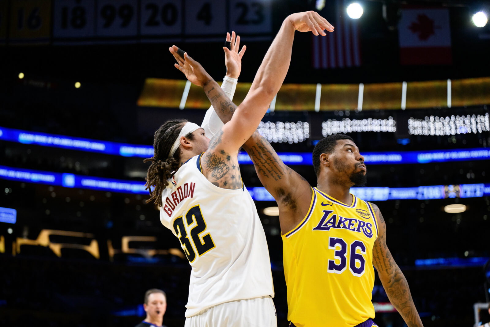 Mar 14, 2026; Los Angeles, California, USA; Denver Nuggets forward Aaron Gordon (32) watches his shot over Los Angeles Lakers guard Marcus Smart (36) during the second half at Crypto.com Arena. Mandatory Credit: William Liang-Imagn Images