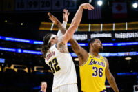 Mar 14, 2026; Los Angeles, California, USA; Denver Nuggets forward Aaron Gordon (32) watches his shot over Los Angeles Lakers guard Marcus Smart (36) during the second half at Crypto.com Arena. Mandatory Credit: William Liang-Imagn Images
