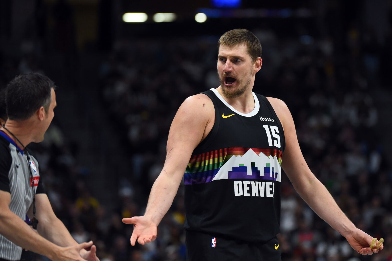 Mar 17, 2026; Denver, Colorado, USA; Denver Nuggets center Nikola Jokic (15) questions an official after a foul during the first half against the Philadelphia 76ers at Ball Arena.