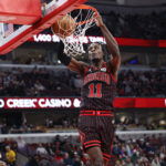 Mar 18, 2026; Chicago, Illinois, USA; Chicago Bulls forward Leonard Miller (11) scores against the Toronto Raptors during the second half at United Center. Mandatory Credit: Kamil Krzaczynski-Imagn Images