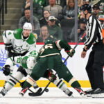 Mar 21, 2026; Saint Paul, Minnesota, USA; Dallas Stars forward Justin Hryckowian (49) and Minnesota Wild forward Mats Zuccarello (36) face off during the third period at Grand Casino Arena. Mandatory Credit: Nick Wosika-Imagn Images