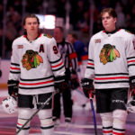 Mar 24, 2026; Elmont, New York, USA; Chicago Blackhawks centers Connor Bedard (98) and Anton Frondell (15) stand for the US national anthem before a game against the New York Islanders at UBS Arena. Mandatory Credit: Brad Penner-Imagn Images